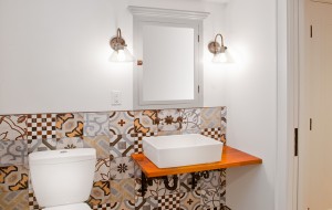 Eclectic tile installation in Minneapolis basement bathroom with vessel sink.
